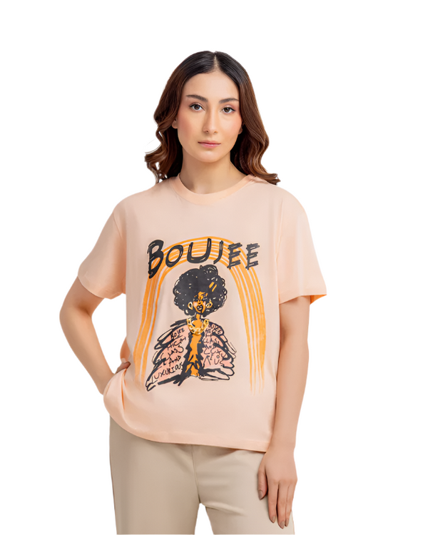 Woman wearing a beige t-shirt with a graphic design on a white background